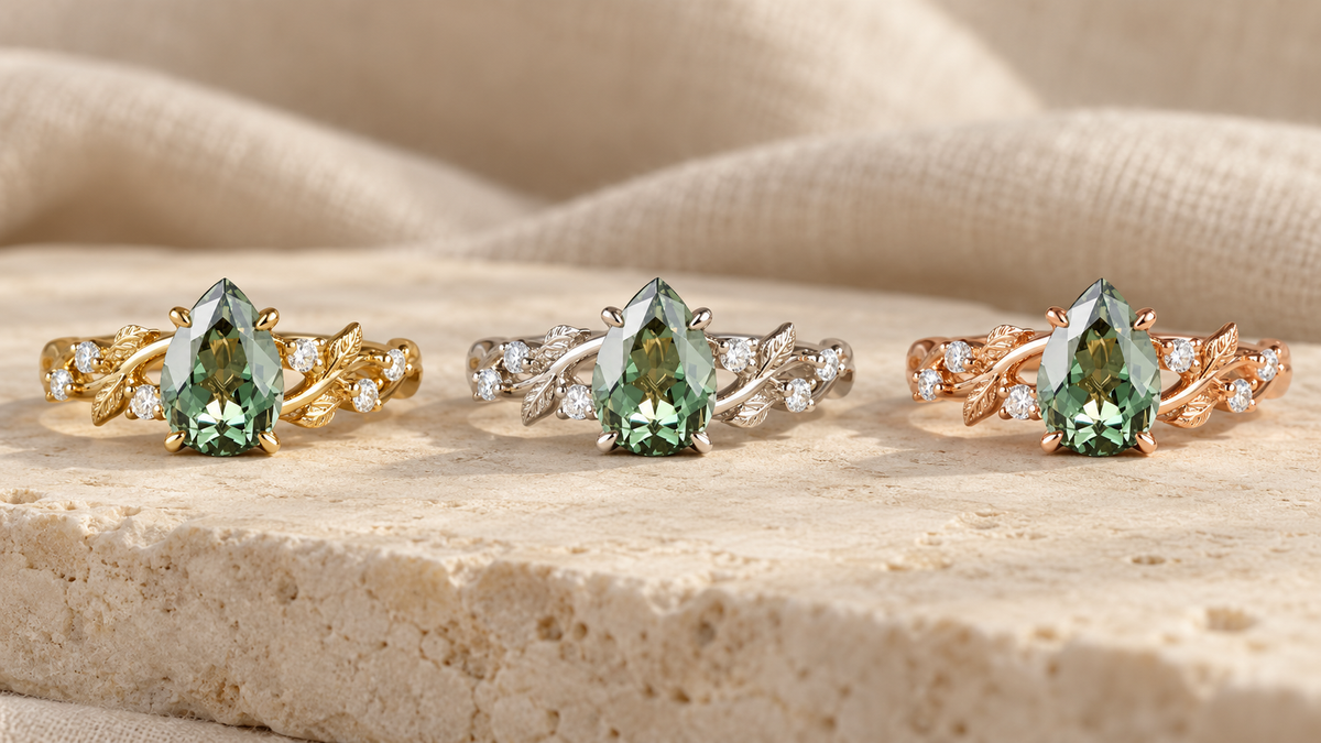 Pear-shaped green gemstone leaf ring shown in yellow gold, white gold and rose gold