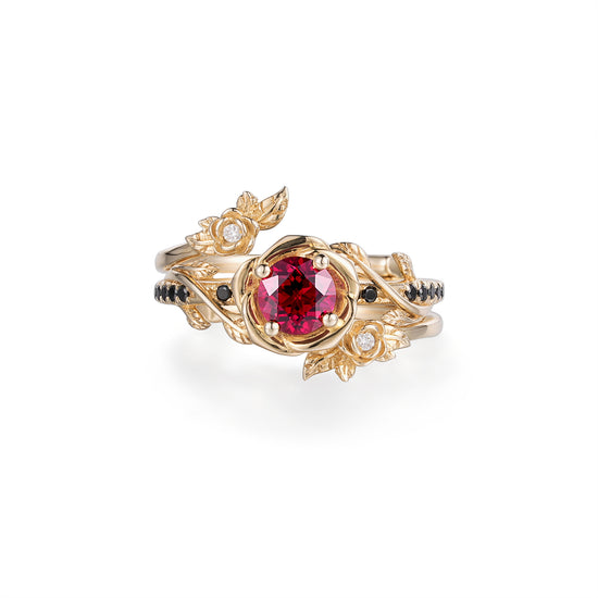 Rose Blossom ruby ring with gold floral accents and black onyx stones.