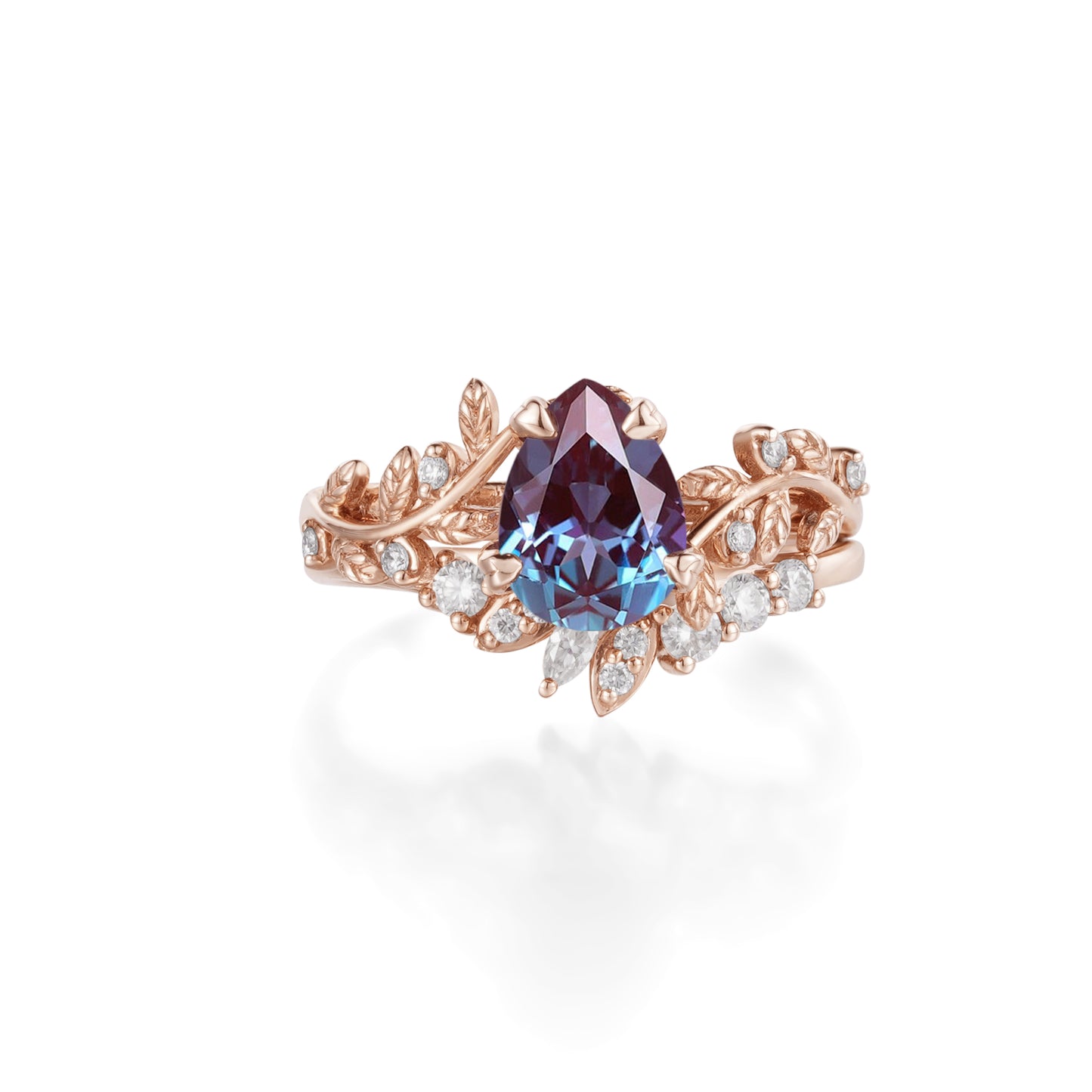 Pear-cut alexandrite ring in rose gold with leaf accents and moissanite stones.