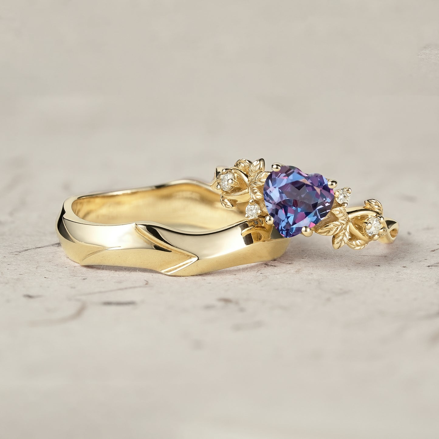 Yellow gold heart-shaped alexandrite ring with floral accents and moissanite.