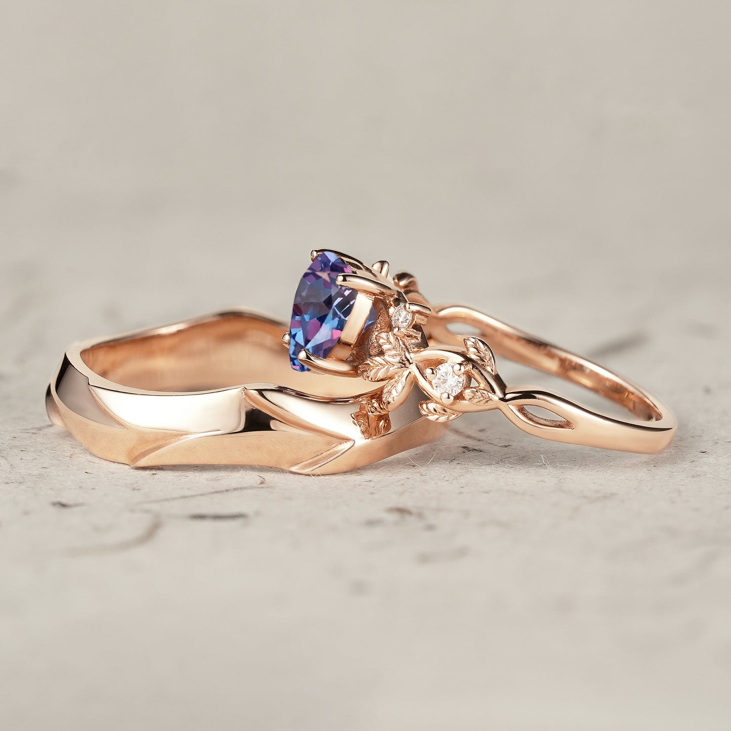 Nature-inspired heart-shaped alexandrite ring set with rose gold leaves and moissanite.