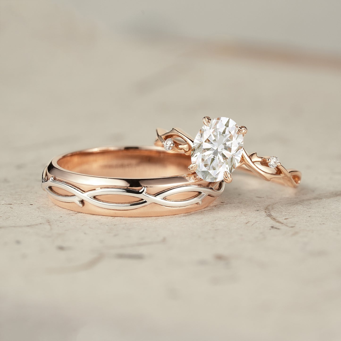 Rose gold oval moissanite engagement ring with vine wedding band set.