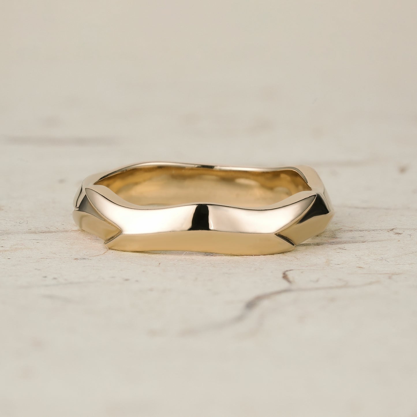 Sculpted modern men's ring in polished yellow gold with distinctive angular shapes