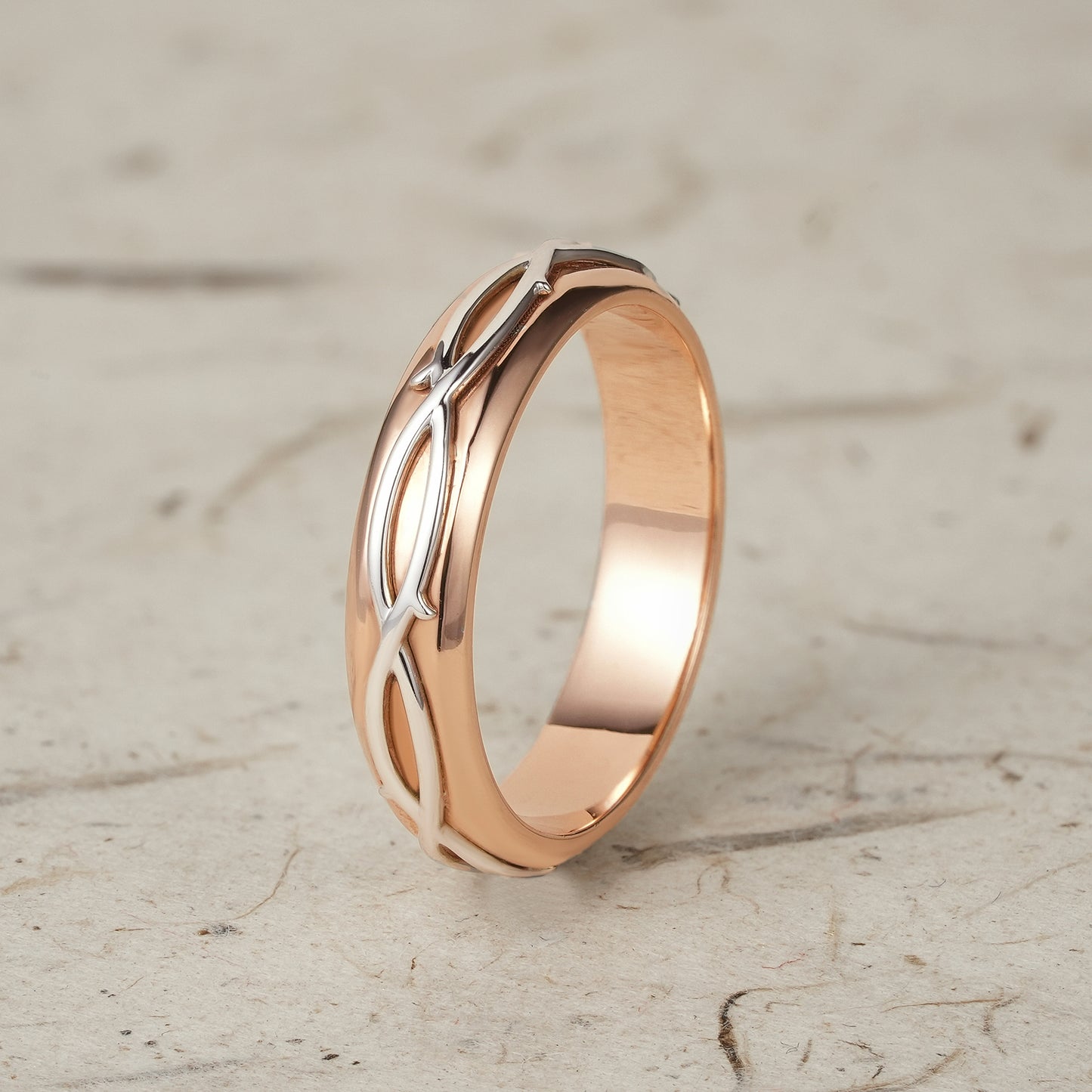 Men's two-tone ring with modern vine pattern in rose gold and polished silver.