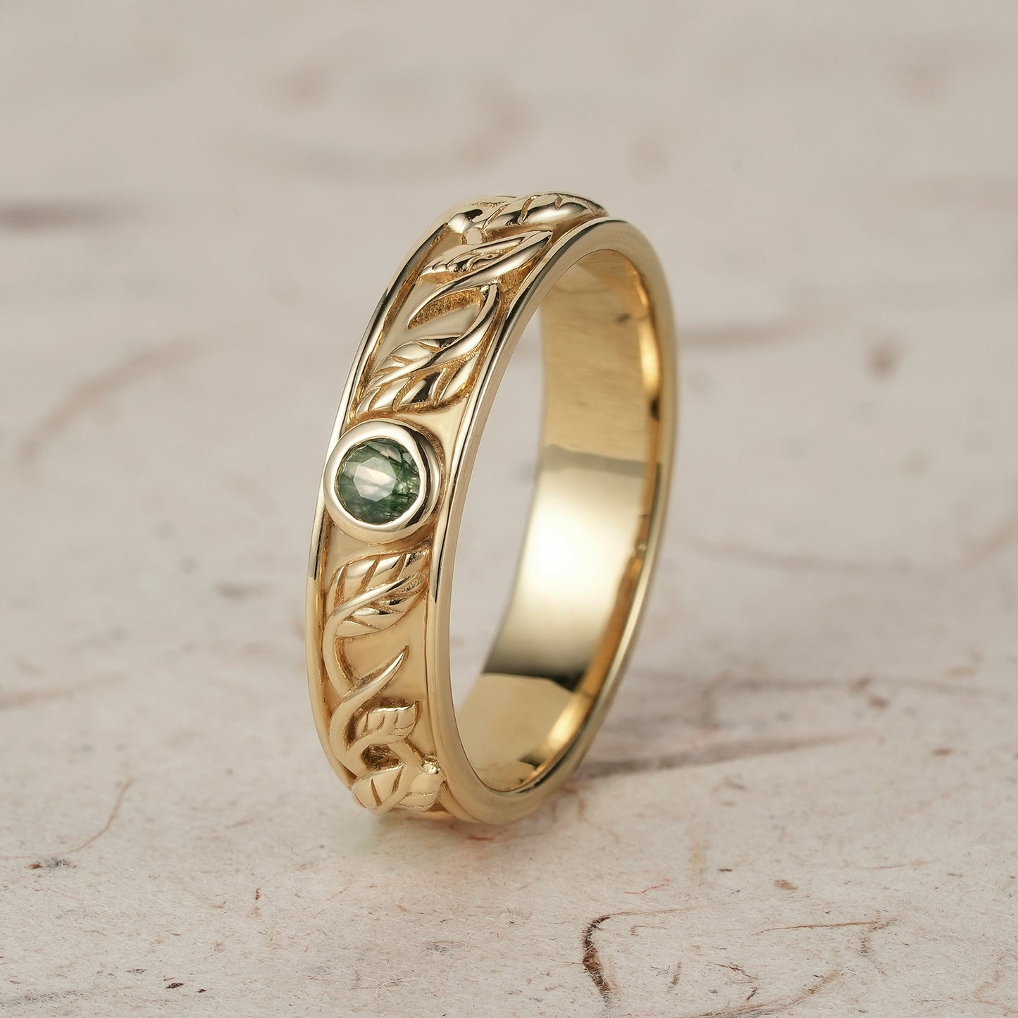 Yellow gold men's moss agate leaf band ring with unique leaf design.