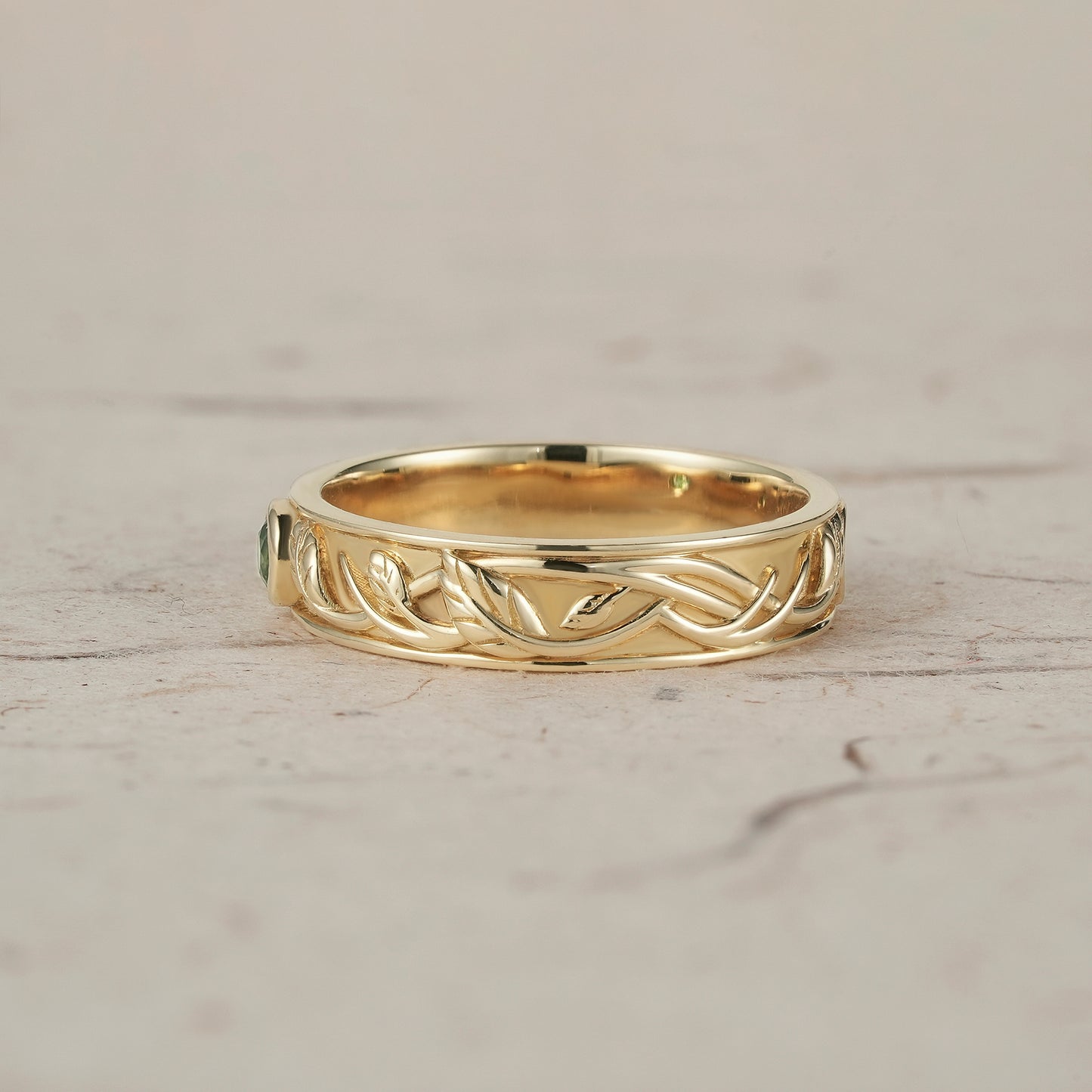 Nature-inspired moss agate leaf band ring in yellow gold with intricate design.