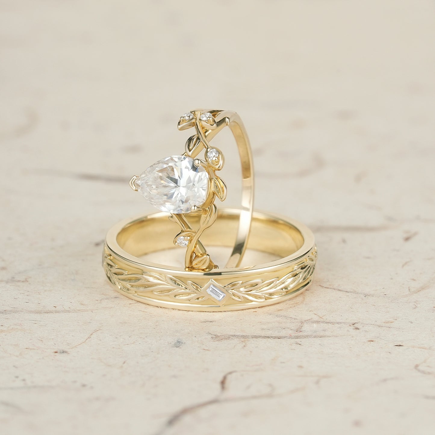 Vine-inspired moissanite couple ring set in yellow gold with diamond accents.