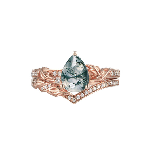 Moss agate pear engagement ring with gold braid design and moissanite accents.