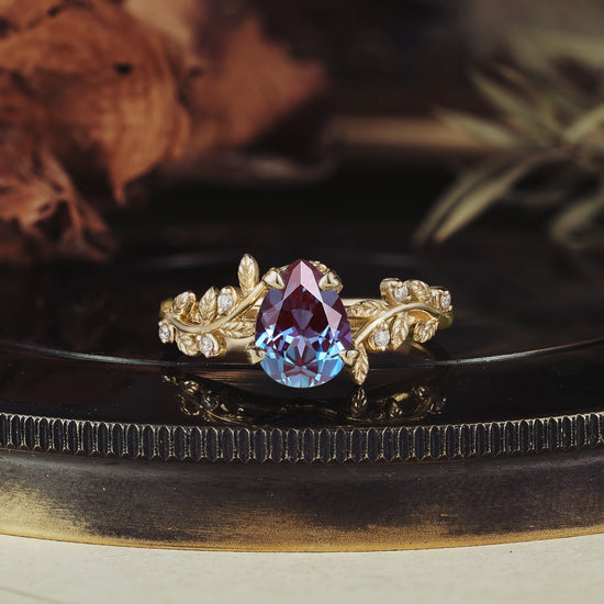 Pear-shaped alexandrite ring with leaf motifs and diamond accents