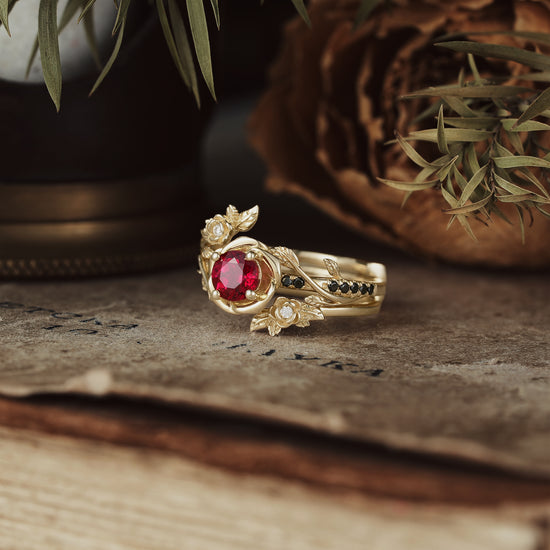 Rose Blossom ruby ring with floral design and moissanite accents on vintage book.