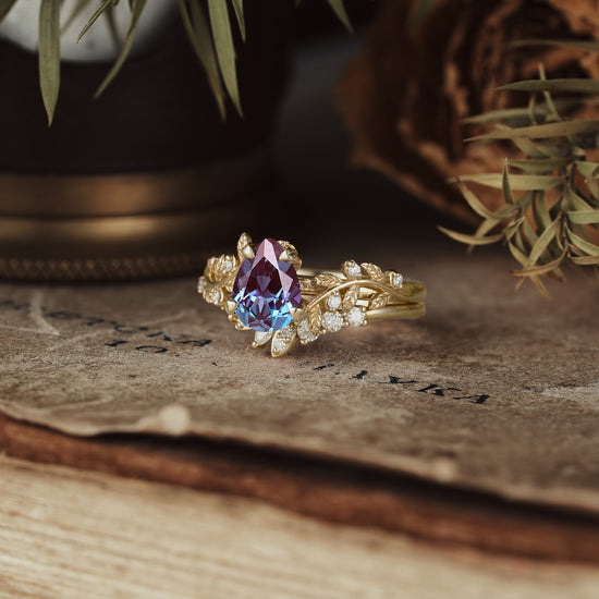 Gold leaf-inspired engagement ring with pear-cut alexandrite and moissanite accents