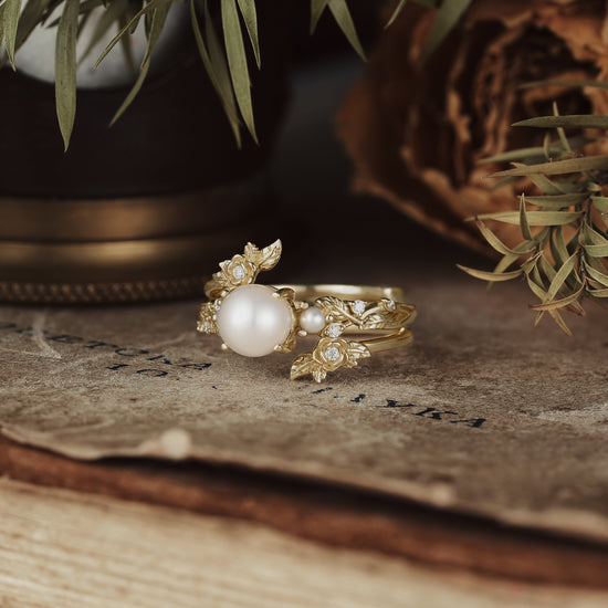 Gold floral ring set with Akayo pearl and moissanite on rustic background