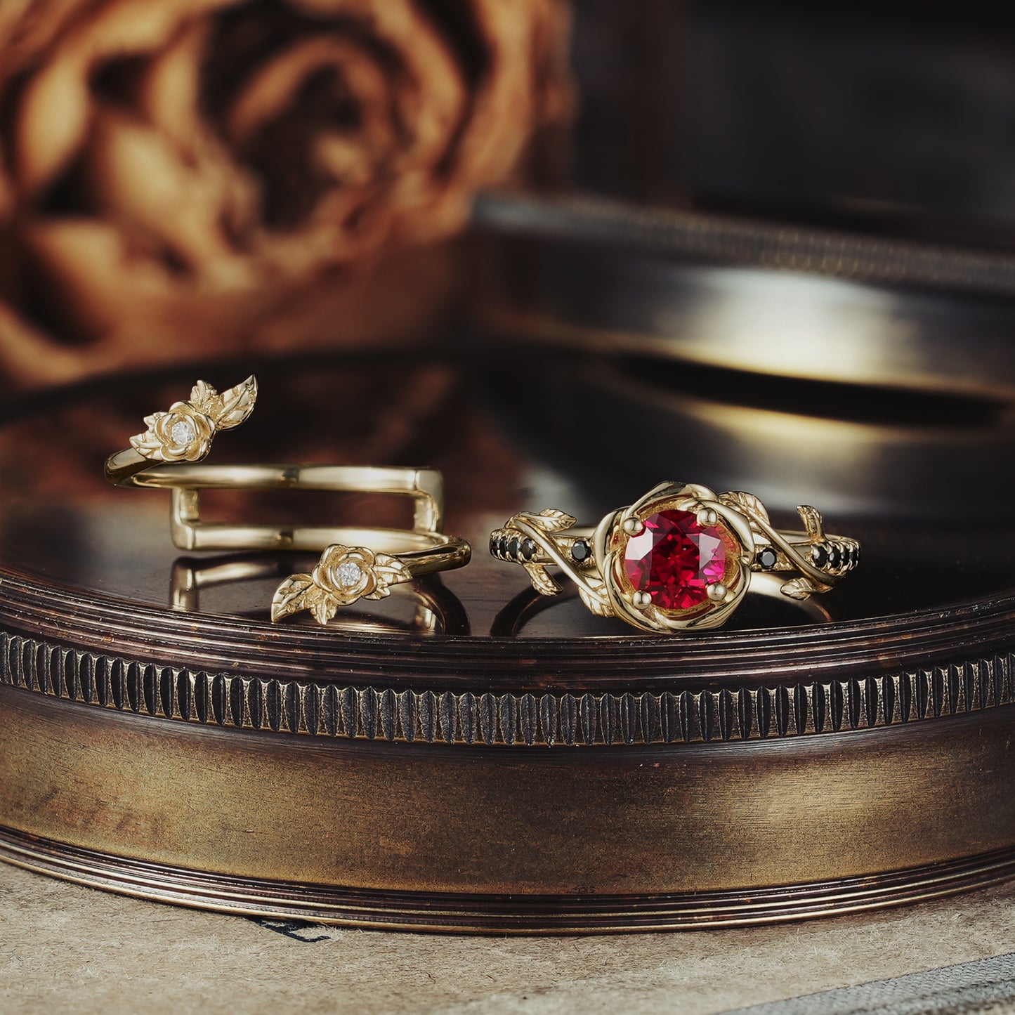 Rose Blossom ruby ring set with gold roses and black onyx on a vintage display