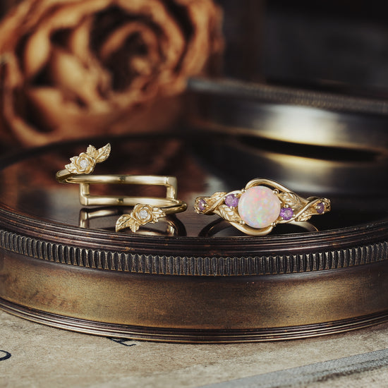 Opal ring set with gold leaf and amethyst, showcasing floral details and elegance.