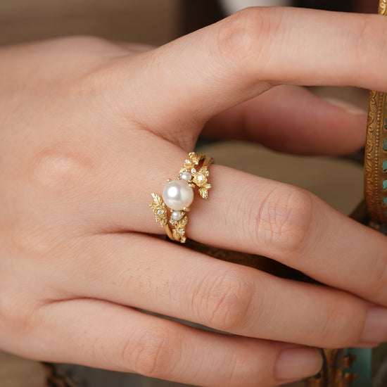 Rose Blossom pearl ring set with Akayo pearl and floral design showcased on a hand.