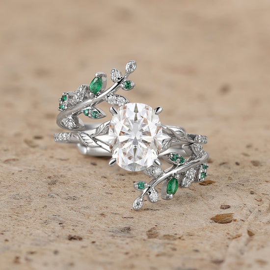 Nature-inspired oval moissanite engagement ring with emerald accents and twisted band