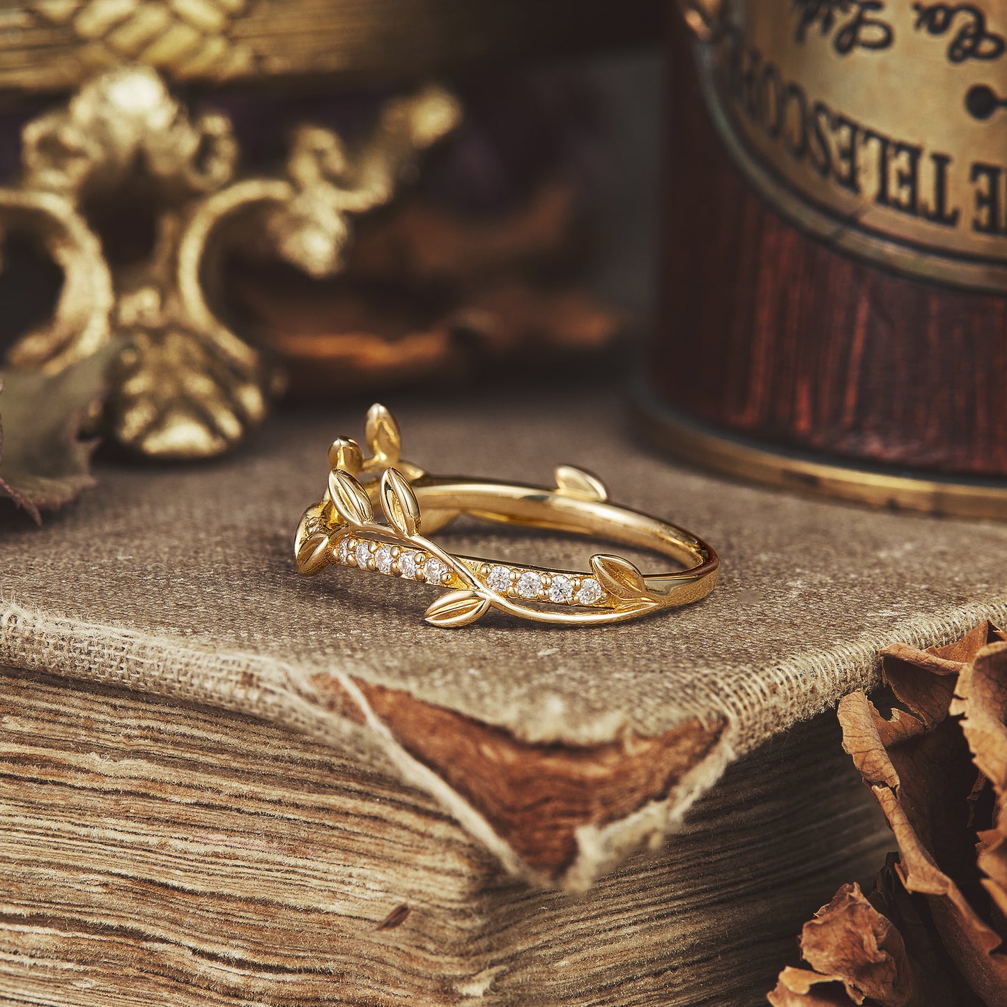 Vine motif wedding band displaying moissanite gems on a rustic backdrop