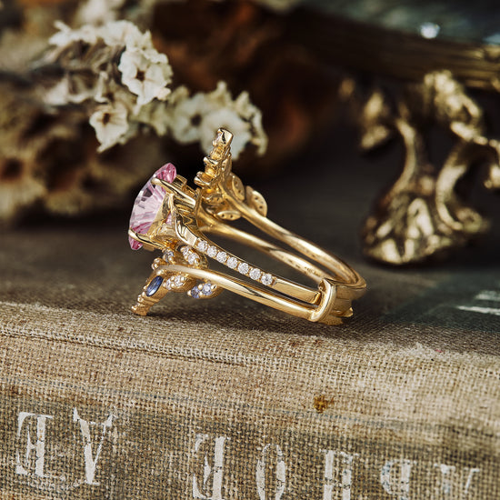 Padparadscha ring set with gold vine accents, moissanite, and sapphire stones