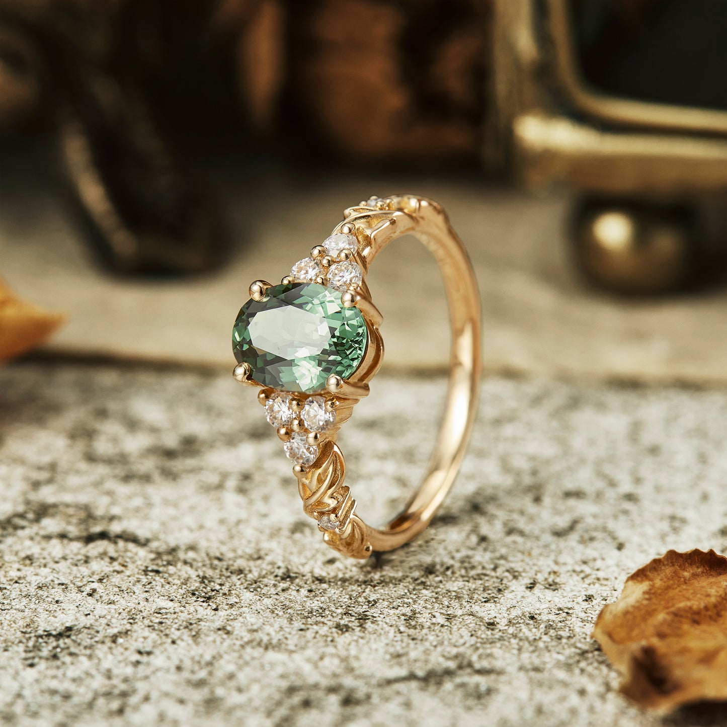 Side view of oval cut green sapphire ring with moissanite on floral gold band.