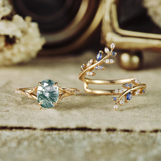 Gold engagement ring set featuring moss agate and sapphire in vine-inspired design