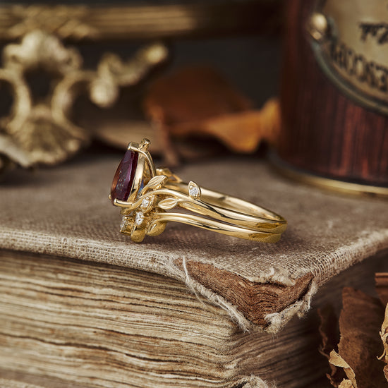 Elegant nature-inspired gold ring with pear-cut alexandrite and moissanite accents