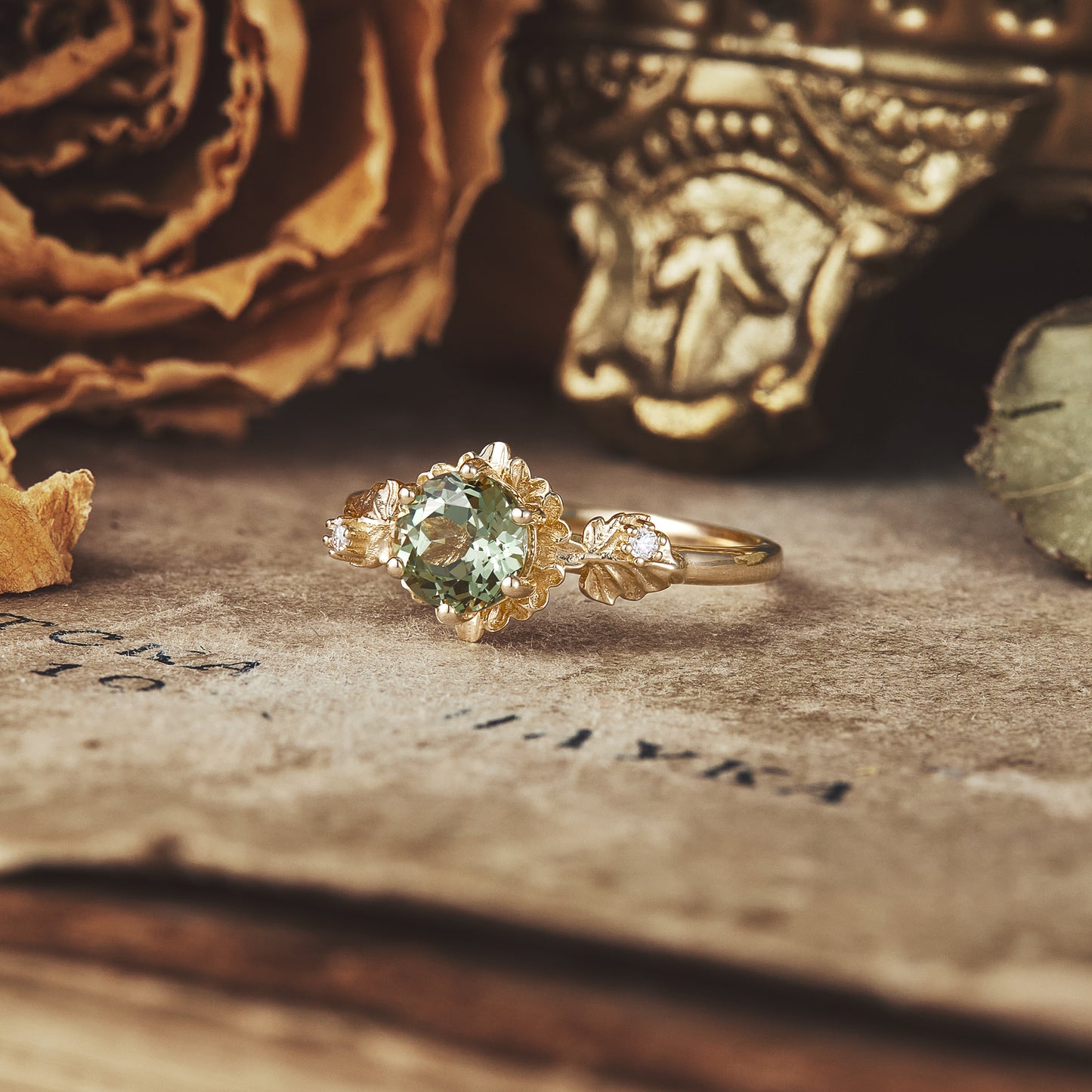 Beekeeper Garden Ring showcasing green sapphire amidst vintage decor and dried flowers