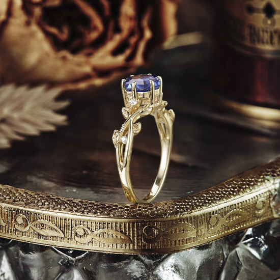 Hexagon sapphire vine ring with intricate leaf details and moissanite accents.