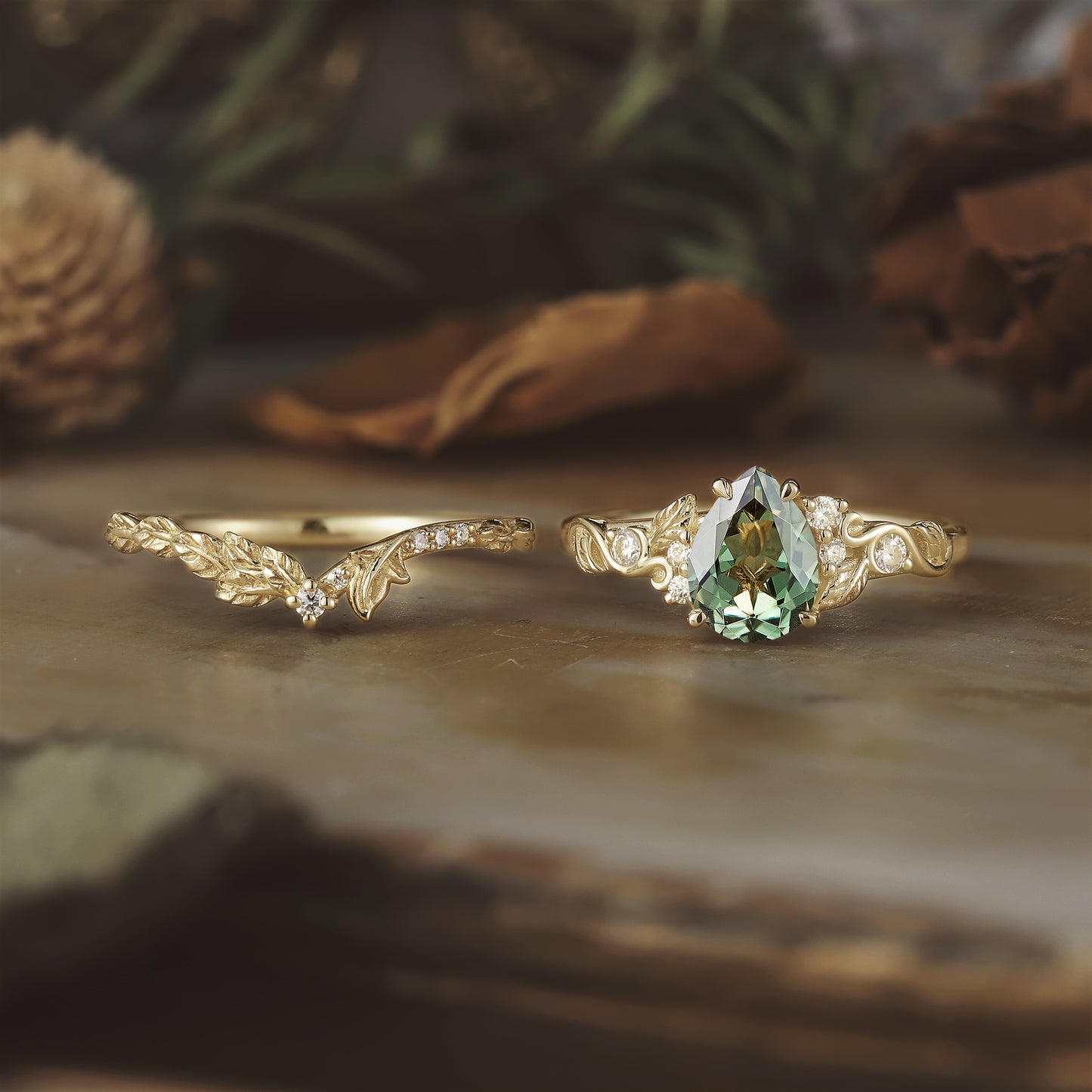 Nature-themed gold rings with pear-shaped green sapphire and moissanite details