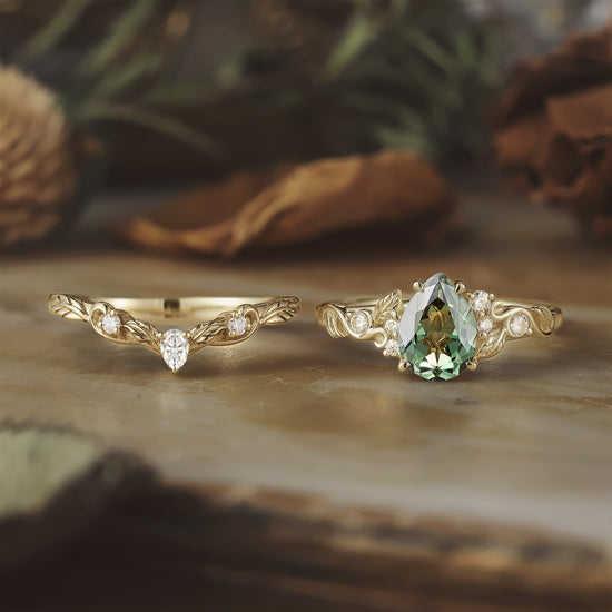 Gold leaf ring set with pear-shaped green sapphire and moissanite gems