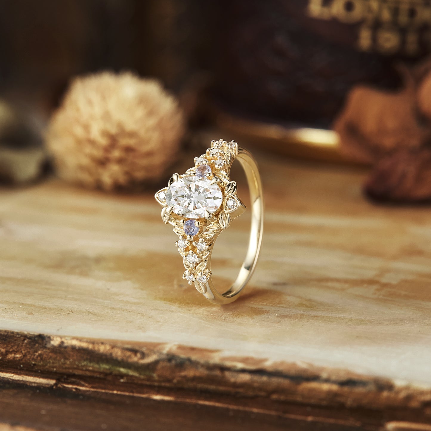 Elegant floral moissanite ring with tanzanite accents in yellow gold.