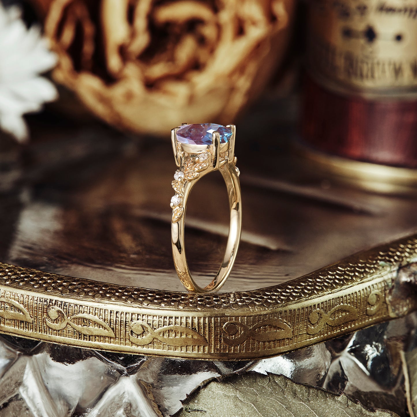 Elegant yellow gold ring featuring pear-cut alexandrite with vine details.