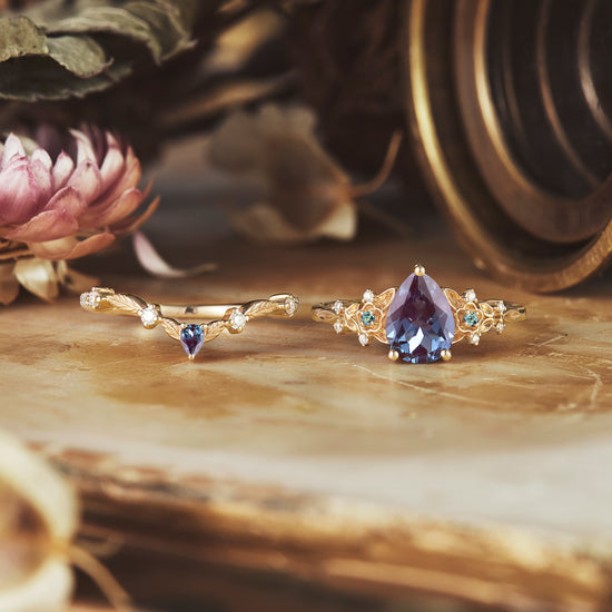 Elegant pear alexandrite ring set with intricate floral details on elegant display.