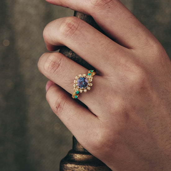 Nature-inspired engagement ring with lab alexandrite and emerald accents in gold setting