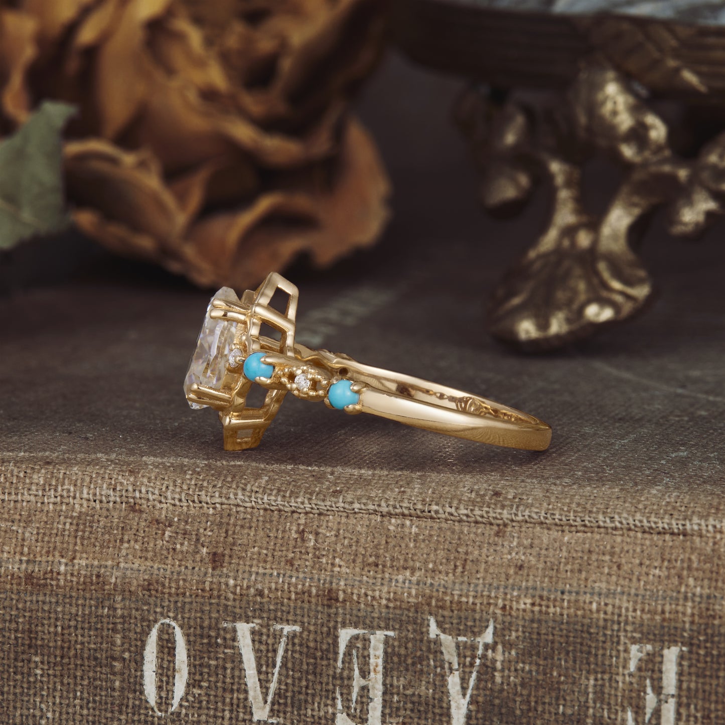 Side view of turquoise and moissanite engagement ring in yellow gold setting