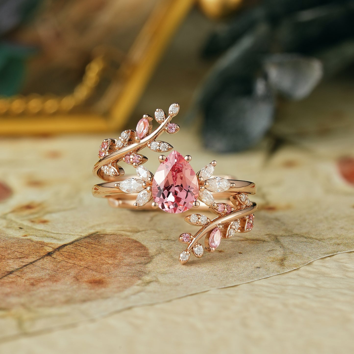 Pear-shaped padparadscha enhancer ring set with moissanite