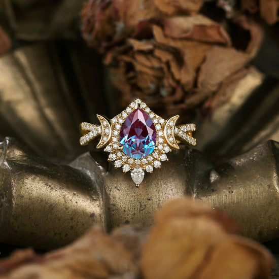 Moon-inspired alexandrite ring with moissanite accents and gold band.