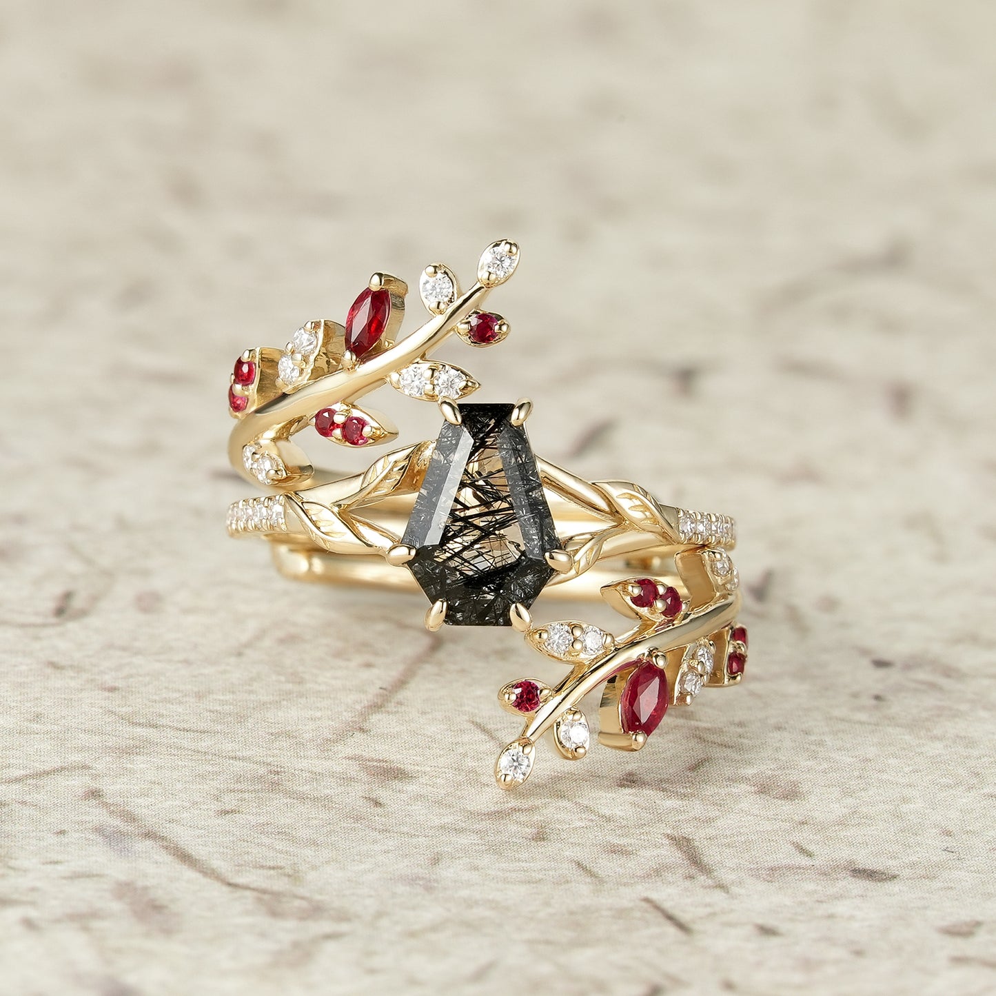 Black rutilated quartz engagement ring with rubies in a nature-inspired setting