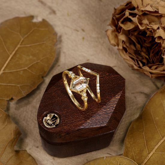 Gold hexagon Herkimer diamond ring set with Moissanite accents on a wooden display.