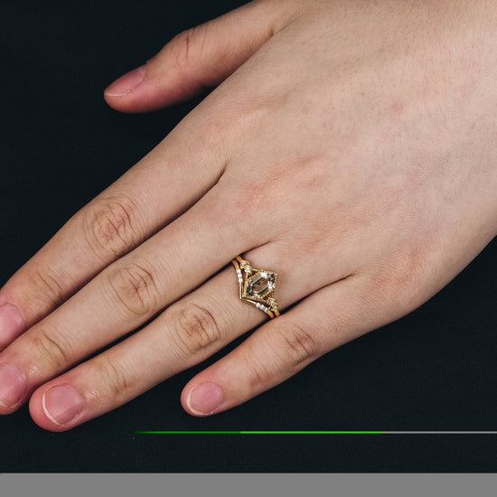 Gold Herkimer diamond hexagon ring set with Moissanite worn on a hand.