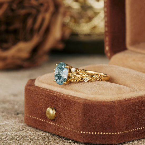 Aquamarine engagement ring with twisted gold band in velvet jewelry box