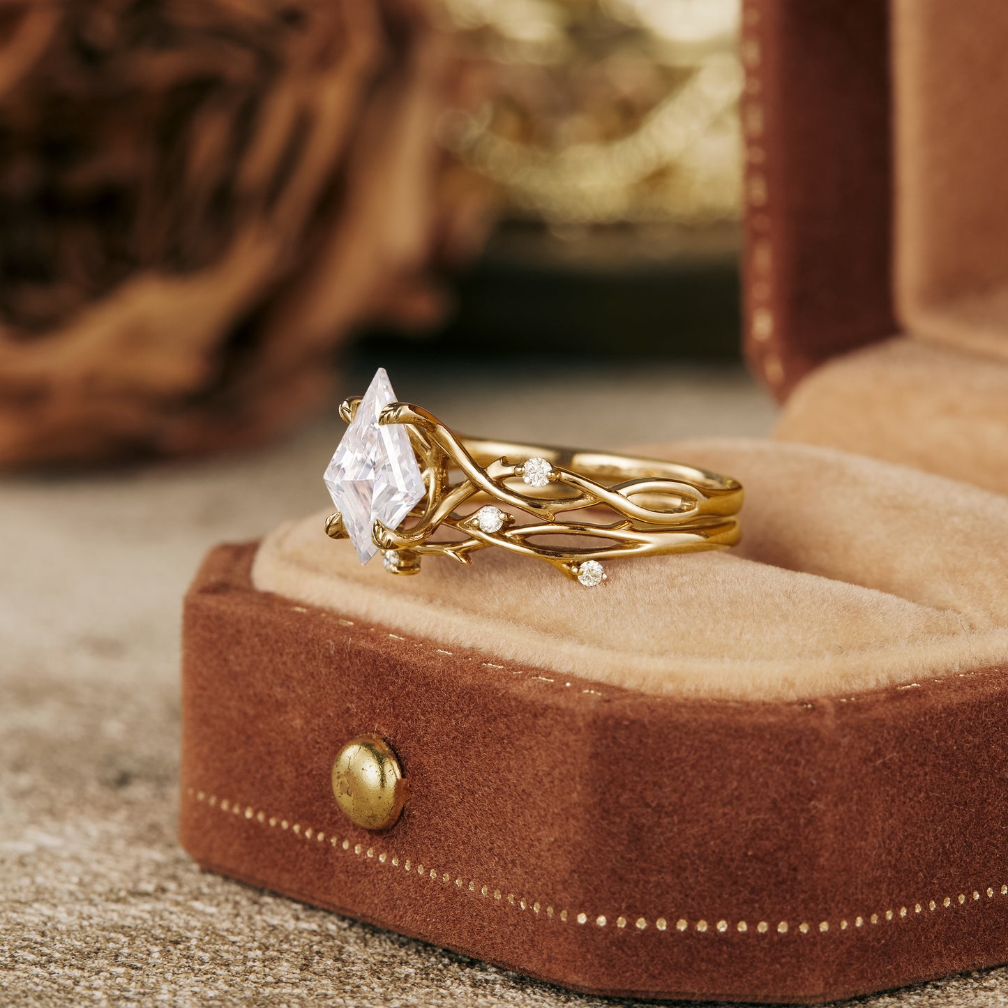 Kite cut moissanite engagement ring in twisted gold setting with accent stones