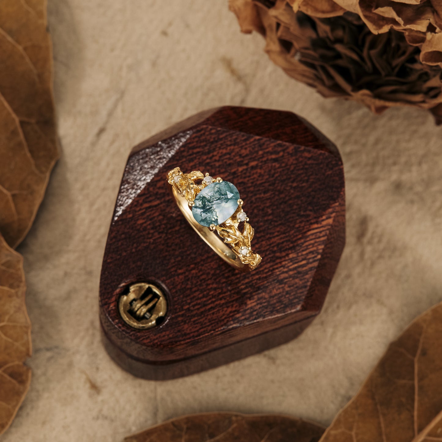 Aquamarine engagement ring with textured gold band on wooden display box