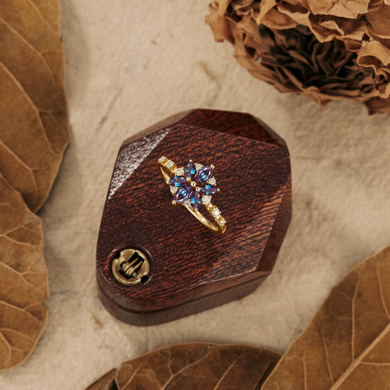 Chrysanthemum-inspired six-stone engagement ring in wooden display box