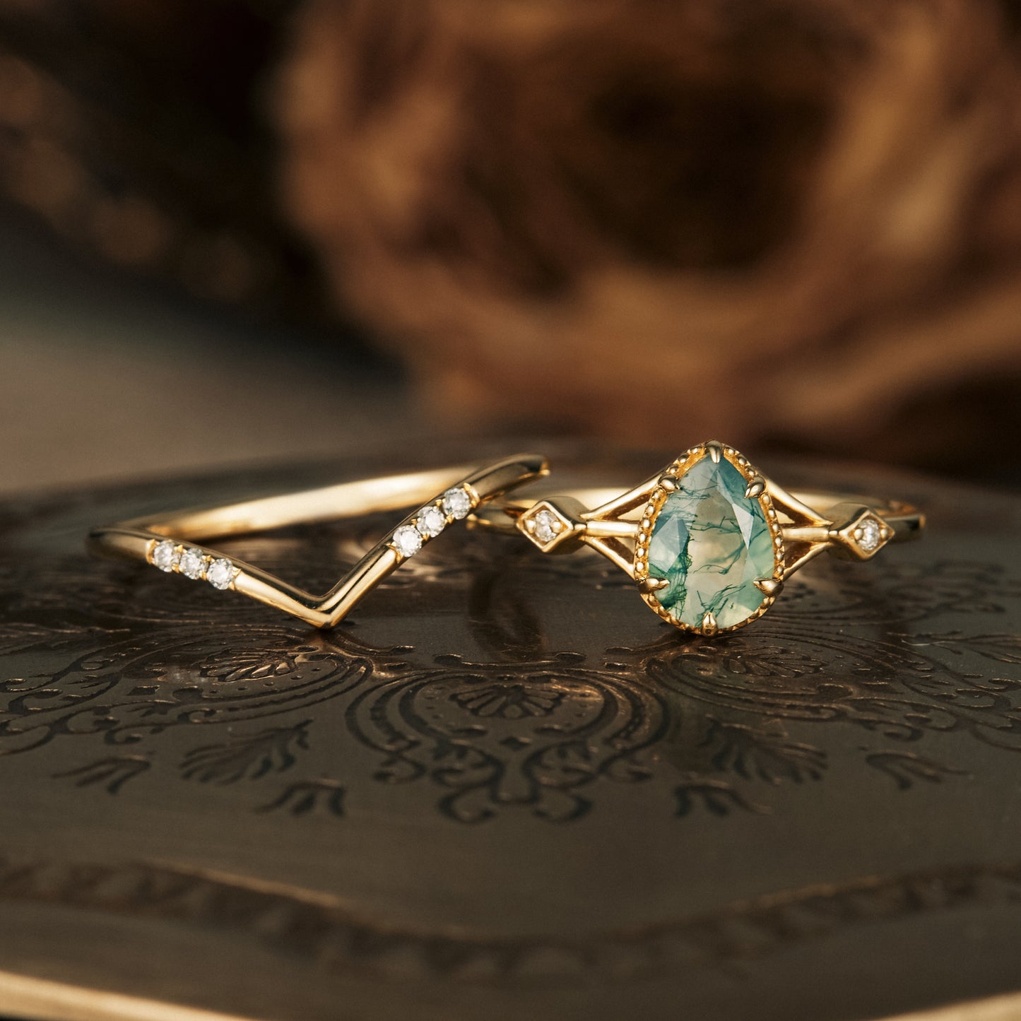 Nature-inspired pear moss agate ring set with sparkling moissanite on gold bands