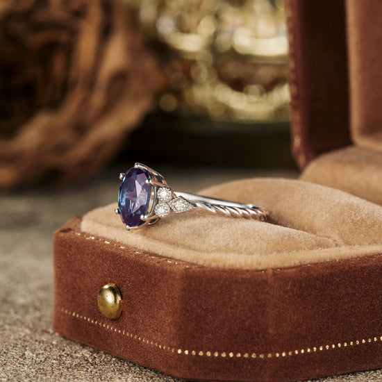 Oval alexandrite engagement ring with moissanite in a velvet ring box